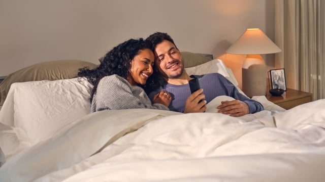 Happy couple laying in bed