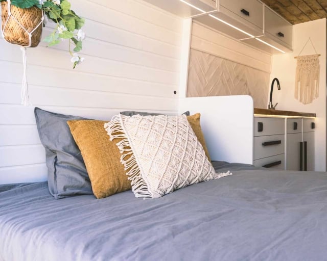 A short queen mattress in a cozy RV bedroom.