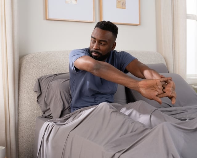 SS sheets gray with talent sitting in bed