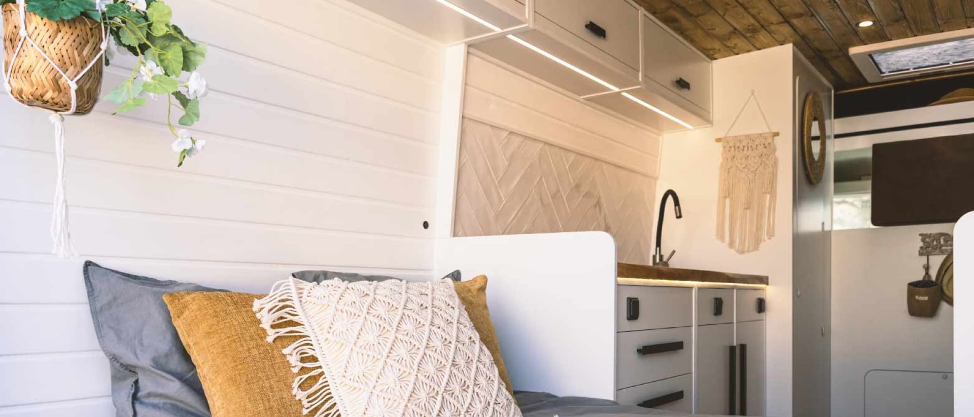 A short queen mattress in a cozy RV bedroom.