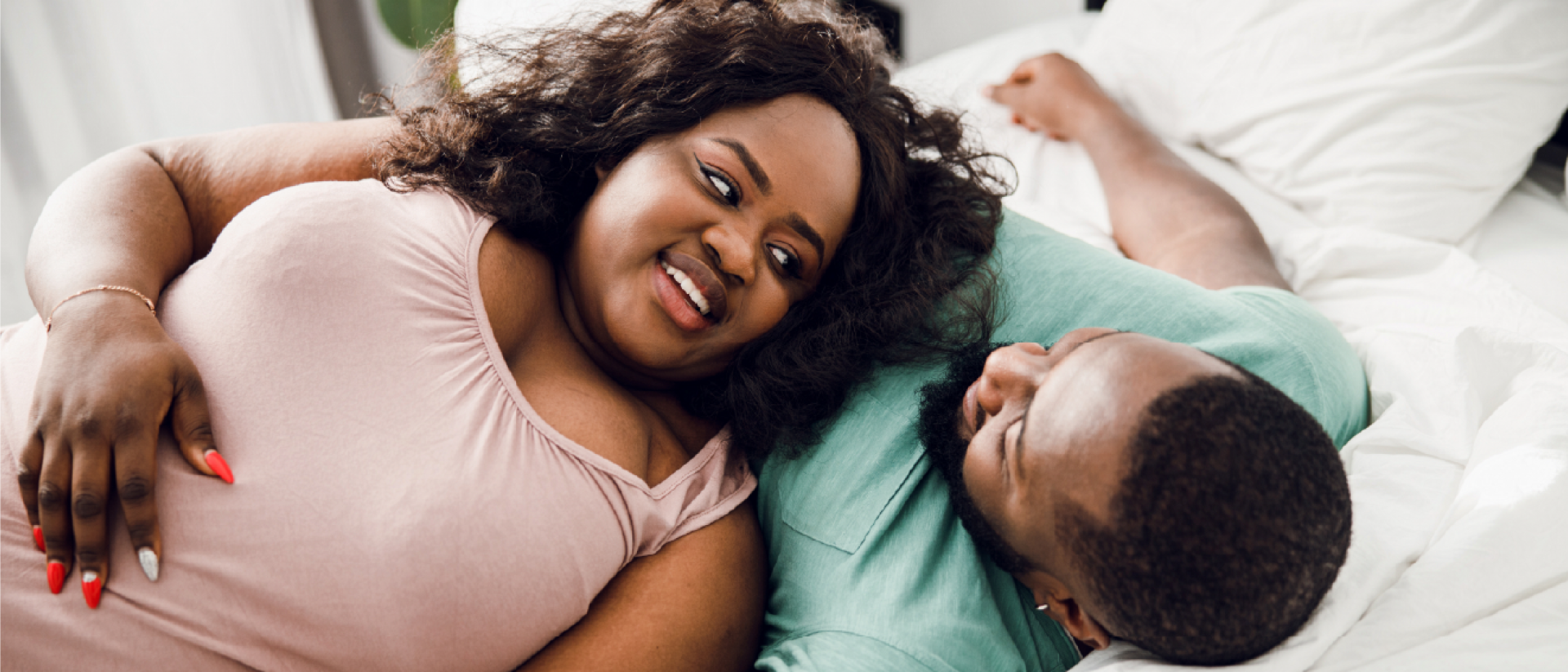 A plus size couple sleeping on a hybrid mattress.