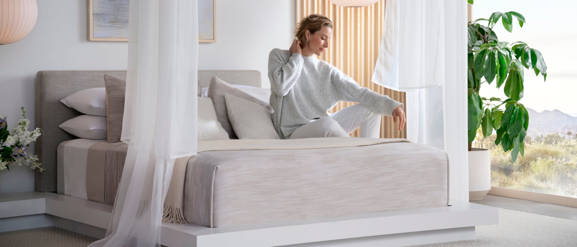 A woman waking up on a Purple Rejuvenate mattress.