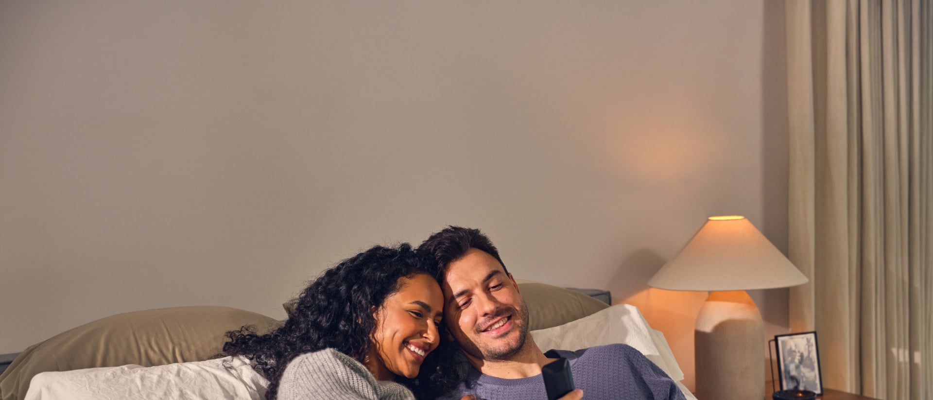 Happy couple laying in bed